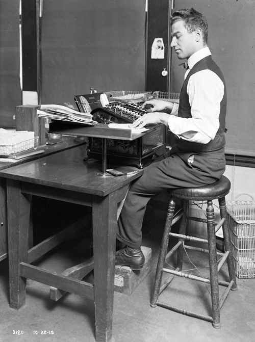 1900s clerk with adding machine